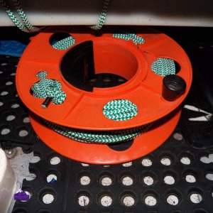 The anchor line is kept on a spool intended for electrical cord.  This is about 140 feet (15-20 pounds?) and still tucks out of the way under the gas tank in the V-berth.  Doing a density/buoyancy calculation, it's about the same as having 35' of 1/4" chain on a 140' rode.