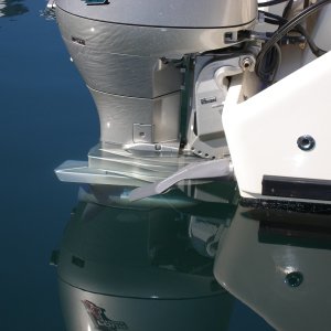 Scupper fix - 3" PVC discharge hose hose-clamped onto the scupper drain.  I saw a smaller version of this on a rigid-hull inflatable.  No water at all came back onto the deck, and everything on deck drained out.