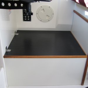 By raising the helm it gave me room to install a 12-inch high storage compartment as a foot rest.