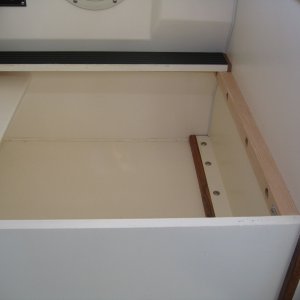 Inside of helm storage box showing through-bolted cleats.