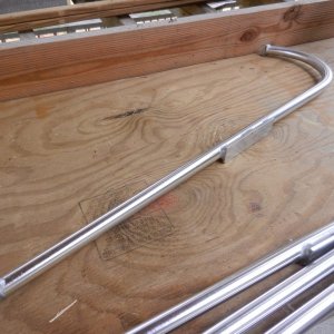 I had a local alumiinum guy bend some 1\" tubing and weld some end straps and a plate on each.  Plate location was an appoximation (with measurements) of the roof rail location.