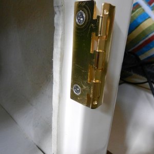 Mounted to cabinet.  There was enough door-edge clearance on all of my cabinets to clear the thickness of the metal.