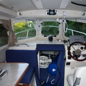 P1000482 berth fan is reversable and swings 180 degrees out of the way. Our stereo a Clarion CMD-06 AM,FM,CD has remote control which will control and charge an IPOD if it is plugged into the supplied USB cable which is routed in clips beside the helms windshield.