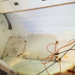 Dining area with water tank and cabinets removed.