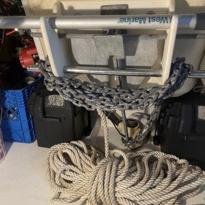 the stainless bar pulls out to instantly release all the chain with the rope coiled on the floor (Behind spare gas container and cooler)