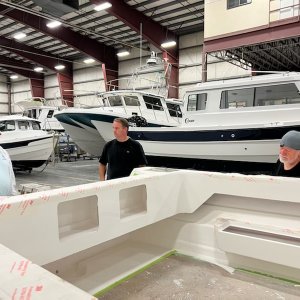 Colby and Harvey listening to Michael talk about building boats at Northwest Marine Industries