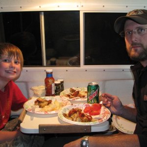 Grayson and his dad Scott, eating the catch.