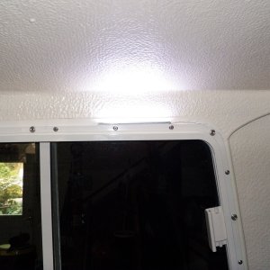 Media 'The have double sided tape on them and are the same width as the aluminum window frame.  I used a creme colored stick on conduit to make the wires disappear.' in album 'I replaced my cabin dome light with these LED lights.  I connected them with phone line wire as they don't draw much.'