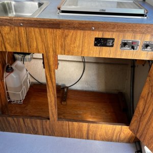 Storage, Wallas Fuel Supply Far Left and Bennett Trim Tab Controls and Reservoir Upper Left Under Counter - ProMariner ProSport Battery Charger Upper Right Under Counter
