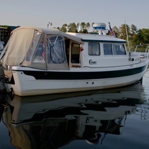 Media 'CEagle-GP-Slip' in album 'Tucked-in-at-Goosepond. The green led rope lights portray a ghostly image. We usually have this marina to ourselves at night.'
