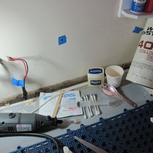 Media 'I filled the cavities about 2/3 full with thickened epoxy(after wetting out). Q-tips were cut in half and used to locate the inserts into this mixture.  The Vasoline was intended to keep the threads from getting fouled with epoxy. I never used it. The blue tape makes removing overflow easy. Nice and Clean!' in album 'IMG 0104'