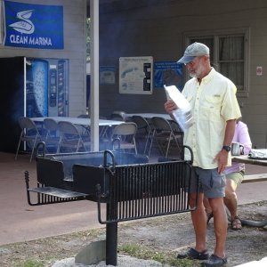 The new grill, donated last year by C Brats, is pondered by Bill.