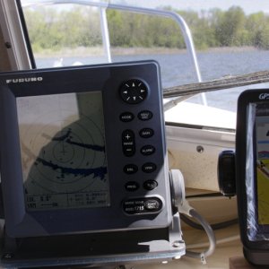 Media 'Moving from the Tennessee River to the adjoining Flint River dead ahead. The GPS route to the FLINT RIVER waypoint is shown on the GPS by a red trace. The Furuno 1715 Radar is interfaced to the Garmin GPS via communication ports. The radar displays a lollipop with the circle showing the entrance corresponding to the GPS waypoint. See the close ups of the GPS and Radar screen for better detail.' in album 'BEFOFE: Original port bench seat with copilot chair for CD 22 Commuter version. Starboard side was identical. This side now has been modified to form a bed and houses a 20 gallon water tank.'