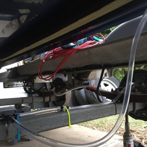 Fresh water rinse hosing under trailer