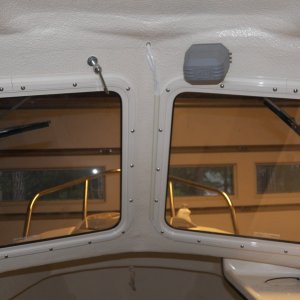 Here is the wiring placed in cream colored conduit running right up the side of the window.  I used this on the transom to cover the depth sounder cable and thought I would try it here.