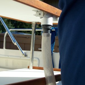 Overboard 1 1/4 inch drain hose attached to top shelf drain