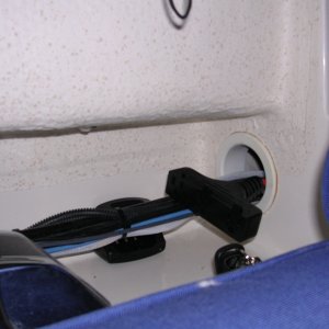 3-outlet extension cord powered by GFI located above house battery.  GFI outlet powered by shore power.