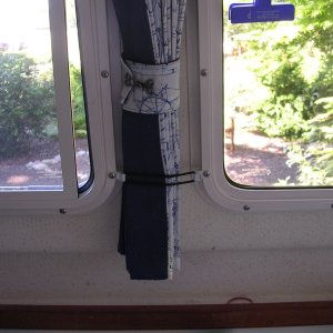Secured curtain.  Keeps the curtains from swinging back and forth, which was annoying while trolling for salmon and trying to watch downrigger rods.