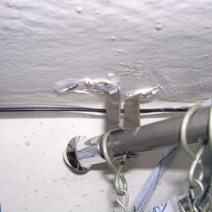 Curtain rod holder; sloppy glue job.