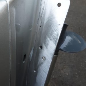 ground off the paint to prepare for the weld.  i should have ground off the paint on the back side too, my weld was not very good and had lots of contamination it it and I think it was pulling paint and crap from the back side into the puddle