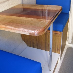 Media 'New table top - Purpleheart, Mahogany, Maple, Cherry, Oak.  Solves 3 issues: 1. Couldn't put old table in or out of berth position without moving seat cushion.  New table narrower. 2. Seat and back cushions use same foam thickness, but seats have 3/4" plywood bottom.  In berth position, table was too low.  New table thicker. 3.  Metal edge around old table made picking up playing cards harder.' in album 'I could have purchased a swim platform made from 'frozen snot' (fiberglass), but decided to build one using teak.'