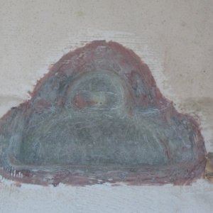 Pigmented resin coat removed; small holes drilled to drain nuisance water until I re-drill main drain hole.