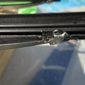 Media 'Small amount of "GooP" on one end clip to secure the rubber in the wiper brackets.' in album 'Old bad wiper blade in holder'