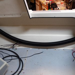 Here are the cables and wires in a flexible tube.  The flexible pipe will allow me to put it in a position to maximize the usable space created by my new hatch.  You can see that all of the seat box pop rivet holes have been drilled out and are ready for the epoxy fill.