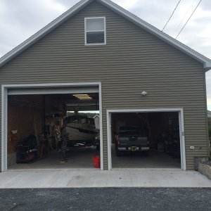 Media 'Garage, view from the west. The boat can be driven thru the garage, so no need to back up and turn around. The door on the right is 8' high and 10' wide.' in album 'New Garage. (view from the east). Man Door and Boat access. Boat door is 14' high and 12' wide.'