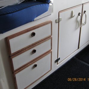 Storage under helm and in galley