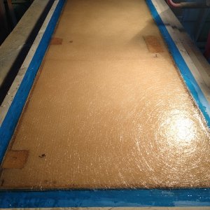 Once the mold was prepped, I brushed on a  Couple heavy coats of Gelcoat. 3 layers of Mat, HoneyComb core, three more layers of mat, Gelcoat. I laminated block of hardwood where hinges, door handle are mounted