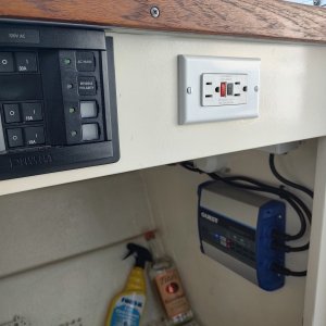 Added Blue Seas AC panel, outlet and battery charger.