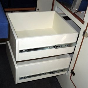 Drawers made from ?in veneer finished plywood painted with tint matched latex paint.  Assembled with glue and pneumatic brad nail gun.