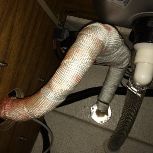 exhaust and muffler to thru hull. dry fit it 4-5 times put rv seal on it and one little corner folded maing it not fit the exhaust out on the heater result was one more cur and red seal all over white wrap...oh well