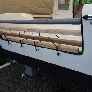 the transom molding was coming loose.  reattached it with 3m 5200 and held it in place like so (days for full cure)