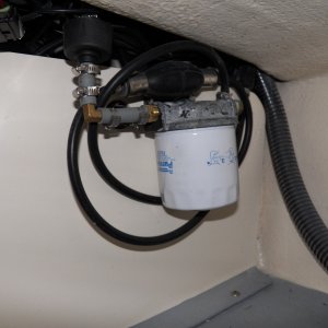 The fuel line goes down the starboard side and the fuel filter is now up off the deck under the splash well.  You can just barely see the fuel management sending unit to the left and above the filter.  I left a standard outboard line and bulb so that I can still use my Yamaha 12 gallon tanks.  Total fuel would be 35 gallons for a range of +200 miles.