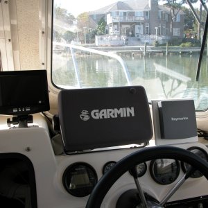 Rear view cockpit camera LCD monitor positioned to the left of the GARMIN 2006C display. Though the location was best for viewing, it proved not so because of water spray when the center window is open.