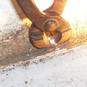 Pulling corroded rivets out of the core after the heads had been drilled off (or the heads had already fallen off).  Here is another picture showing that the bead of caulking could hold dirty water behind the panels and contribute to the leaking pop rivets.