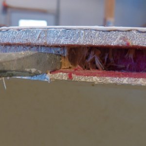 The wood appears to be okay, but I'm digging it out enough to replace with epoxy putty and protect the balsa core once it dries out in a few months.