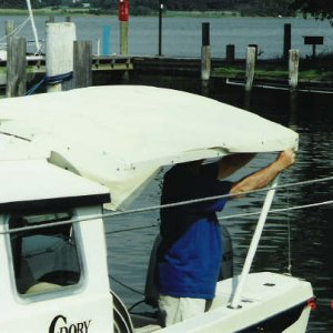 Media 'Canvas is snapped on.
Only takes 5 minutes to put the top up and we have shade.  Also helps when raining, we can keep cabin door open.' in album 'Anchored off Ordinary Point, Sassafras River'