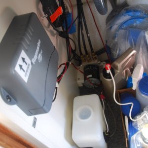 The water tank is located under the sink and below the Autopilot CPU - beside the hydraulic pump.
NOTE: Windshield Washer Fluid should be mixed with fresh water to minimize any 'crud' buildup in the lines and heads with full strength used as you would your car when approaching the colder seasons.

The brown jug, behind the white washer tank, is a pump sprayer from yard work that I used to spray fresh water on the windows. (One more item I can remove in the near future.)