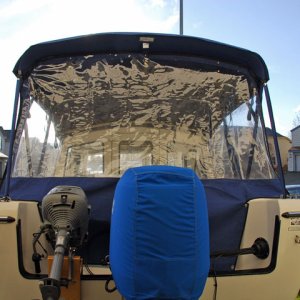 Canvas stern view.  Main engine can tilt up without any problem.