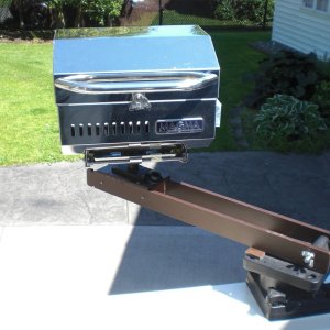 Swings out ready to BBQ.  Any grease or drips are well over the side, not on the boat.