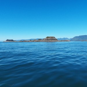 Outlying islets in front of the Bunsbys with the Brooks Peninsula in the background.