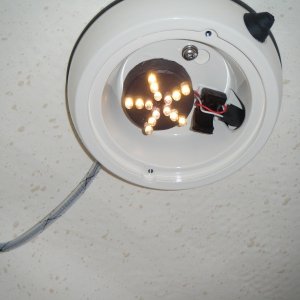 Cabin light lens off.  LED draws .009 amps.  Clip off old socket and solder to existing leads. Light mounts to factory frame with marine adhesive. (11MAR10)
