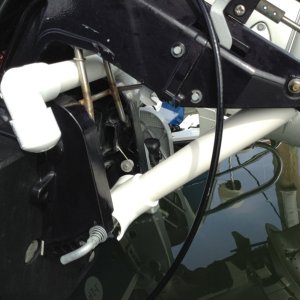 03 Here, the T-Support securely holds the motor in place taking pressure off of the bracket. The "T" end slips over the reverse lock rod.  The motor is very solidly held in place by this support.  The horizontal 3/4" PVC pipe with elbows above it is inserted at that location just in case the T-Support disengages. It also saves me from harm should the T-Support accidentally disengage. I DON"T RECOMMEND OTHERS SHOULD TAKE MY ACTIONS. JUST BE AWARE OF THE ISSUES THIS MODEL CAN CAUSE.  BUT IF ANYONE WERE TO DUPLICATE THIS SET UP, NEVER USE THE T-SUPPORT WITHOUT ALSO USING THE HORIZONTAL ROD AS A FAILSAFE MEASURE TO PROTECT PERSONS AND PROPERTY.  Finally, I only used this set-up for about 90 miles.  I don't know whether or not PVC will be elastic enough over time to withstand the stress.  Next year, I am thinking about constructing a similar set up out of steel pipe.  Naturally, the cradle will have to be rubberized if steel is used.