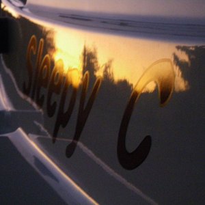 Sunset Reflection on the SleepyC port side name plate.