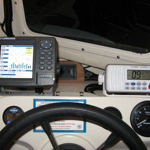 The Lowrance and the Icom are pretty happy together.  The Lowrance causes a slight amount of interference on the VHF on certain channels.  I've loaded all the wires with ferritte cores, with the exception of the VHF antenna cable.  I think the interference is coming out of the Lowrance display anyhow.  You can block some of it with your hand or a sheet of metal.

The Lowrance is an LMS-337C DF and the Icom is an M422.