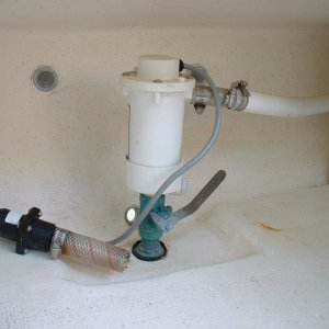 Media 'Here are some photos of the live bait well plumbed into the port laz by the dealer for the previous owner. The clear hose with check valve on the left is the intake for the manual bilge pump. This photo shows the bait pump with bronze through hull and valve.' in album 'Here are some photos of the live bait well plumbed into the port laz by the dealer for the previous owner. The clear hose with check valve on the left is the intake for the manual bilge pump. This photo shows the bait pump with bronze through hull and valve.'