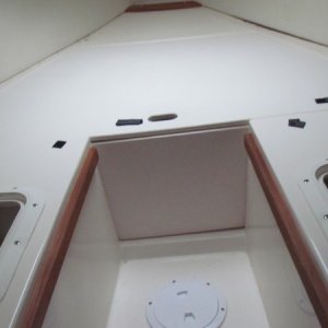 the smaller hatch on the port side is where my wife stores her clothes and starboard side is where I keep my clothes.Black spots are velcro for trying to keep cushions in place